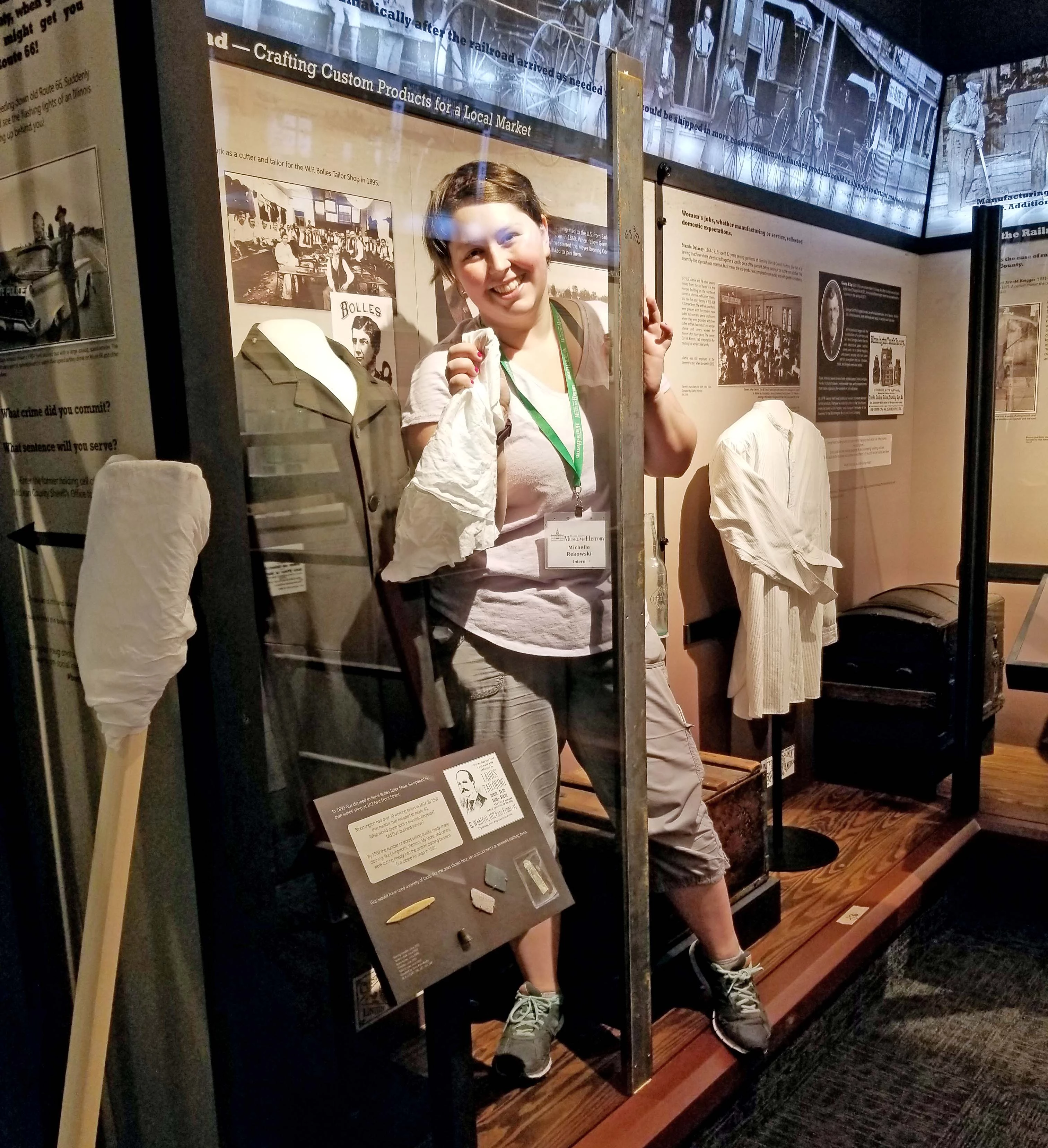 An intern cleans the glass in an exhibit