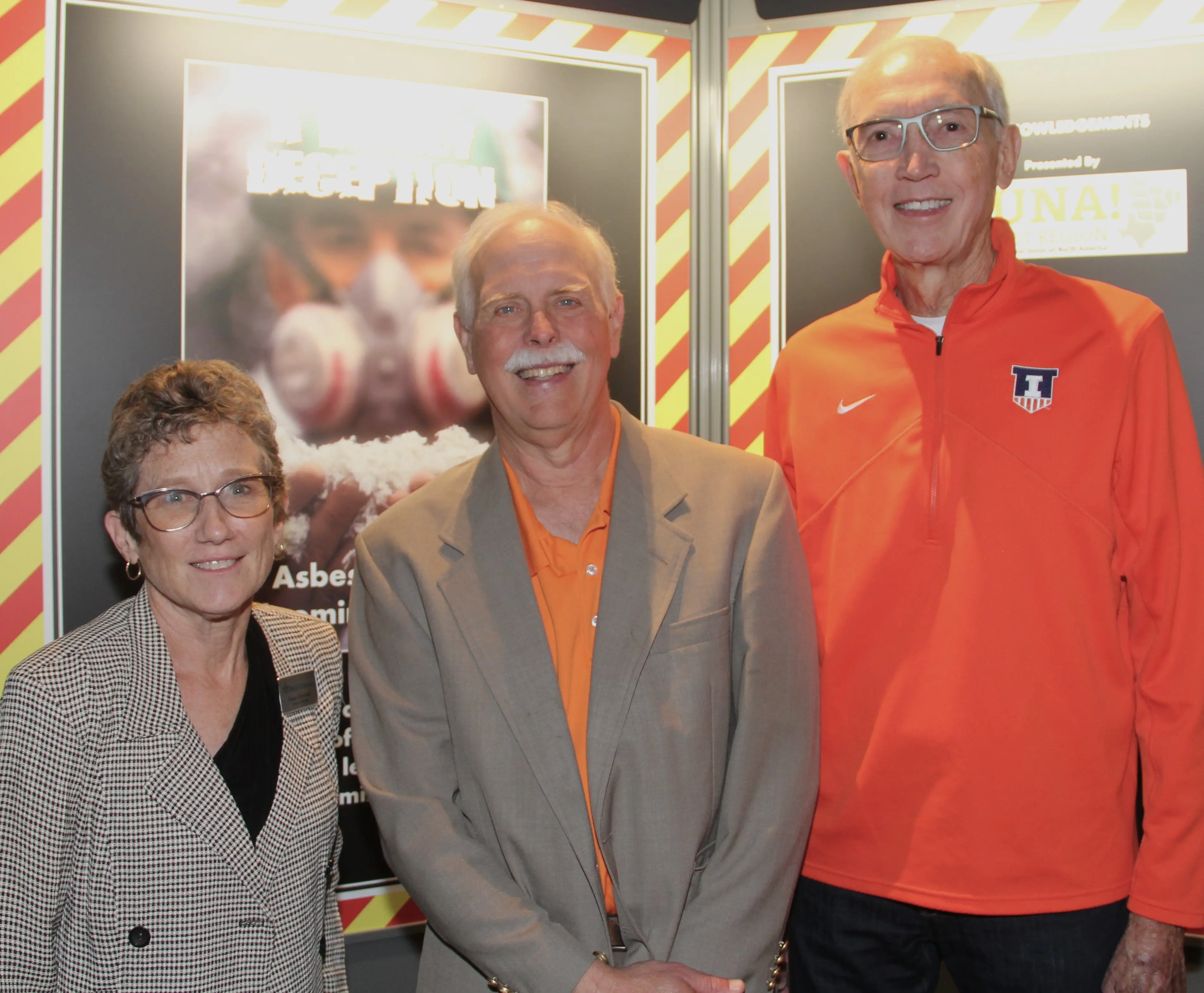 Co-curators Susan Hartzold (left) and Mike Matejka (middle) pose with attorney Jim Walker (left) at the during the 2024 exhibit opening of A Deadly Deception: The Asbestos Tragedy in McLean County. Walker represented several local workers in class action lawsuits against asbestos manufacturers, such as UNARCO. His assistance, which included a large donation of primary source materials, was vital to producing the exhibit.