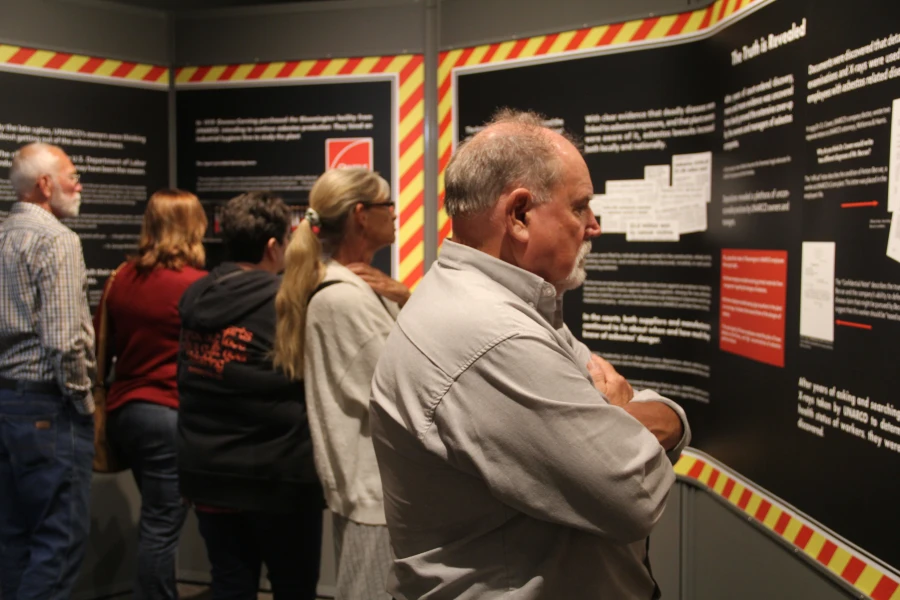 Museum visitors view exhibit panels during the exhibit opening in 2024.