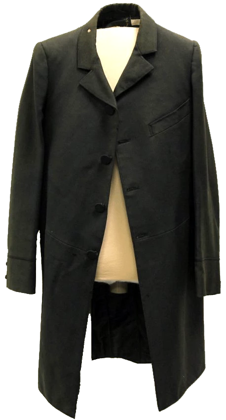 Black coat that has faded a bit over the years, with black buttons, chest pocket, and buttons on cuffs. It appears approximately mid-thigh length.