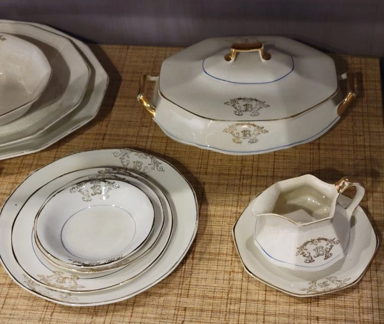 These dishes are white with gold trim and an ornate gold.