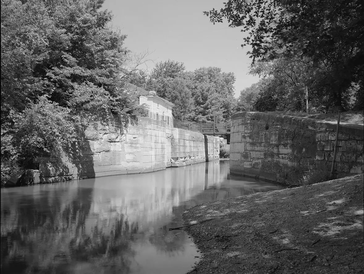 image of a waterway with tall stone edges and trees surrounding.