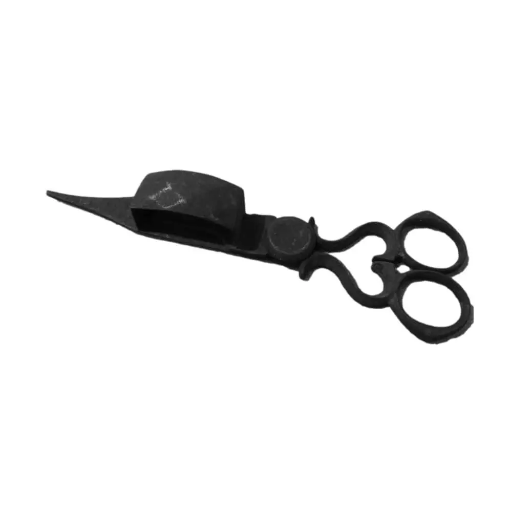 Photo of a black iron object shaped somewhat like a pair of scissors, except that it has a large box shaped protrusion halfway down the scissor.