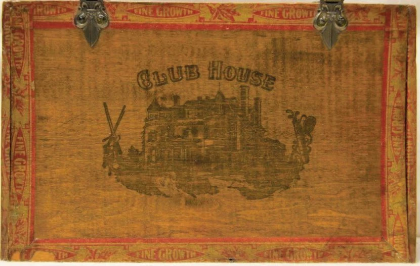 An brown cigar box with Club House printed on it. It features an outline picture of a manor.