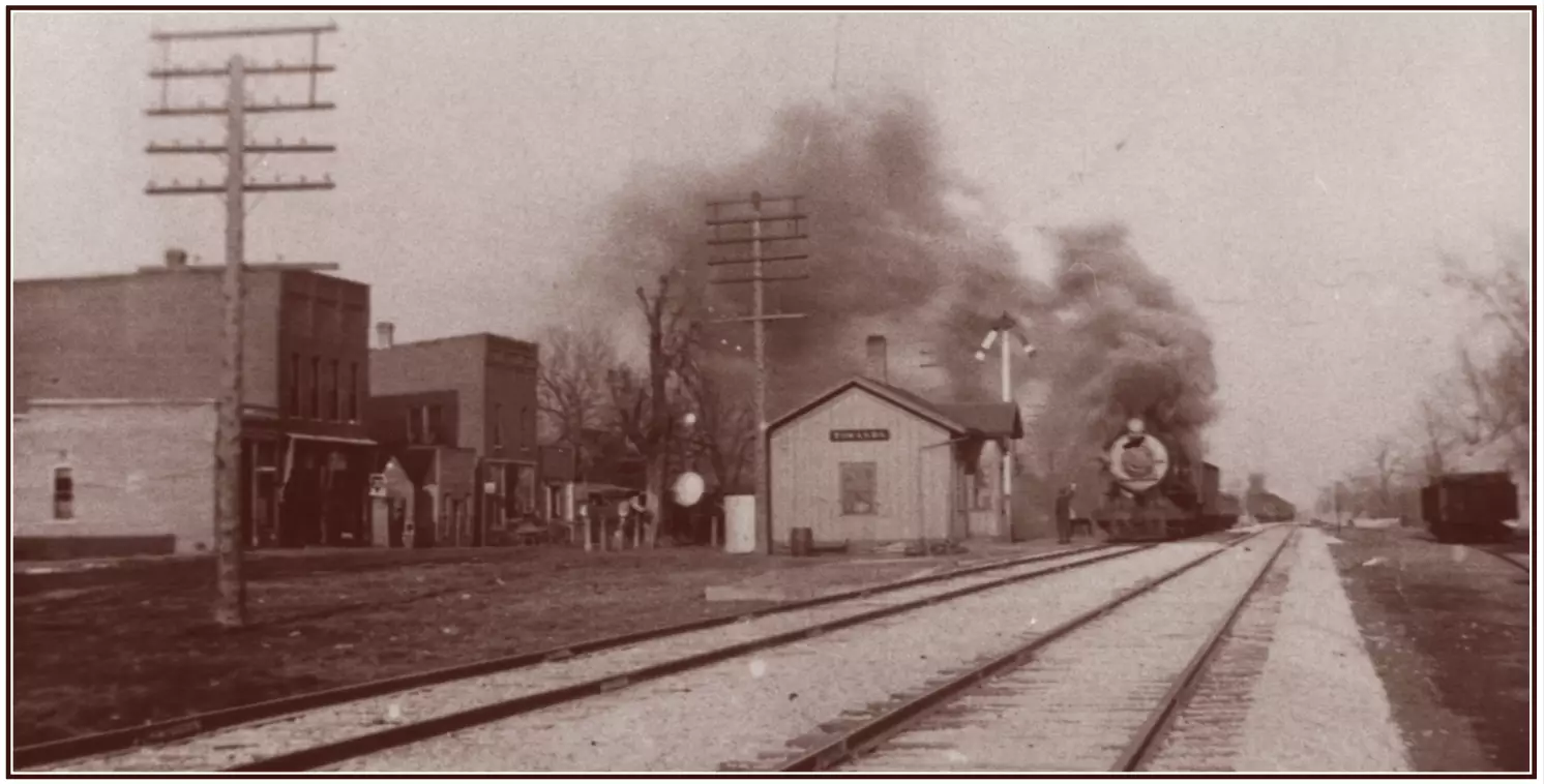 image of railroad tracks and buildings next to the tracks