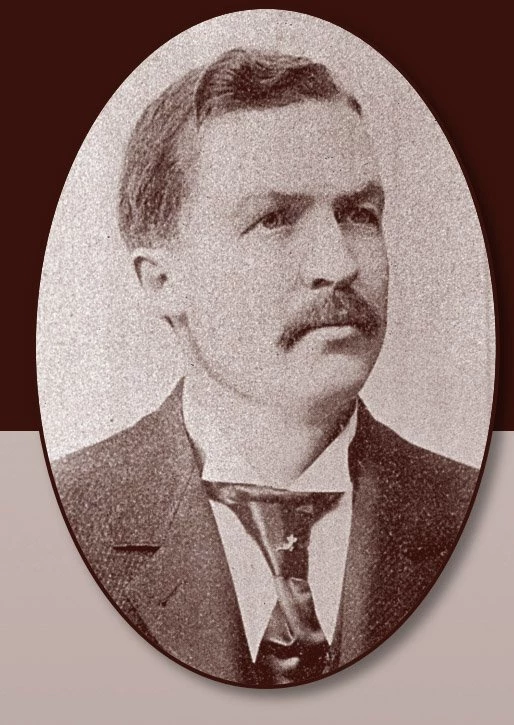 Portrait of Patrick Morrissey, a white man with a mustache wearing a neck tie and suit jacket.