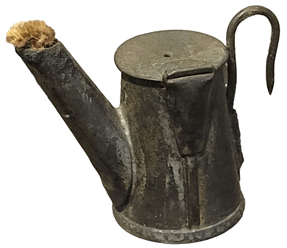 Metal can with a spout that appears to have paper stuffed into it. There is a flat lid and a hook handle.