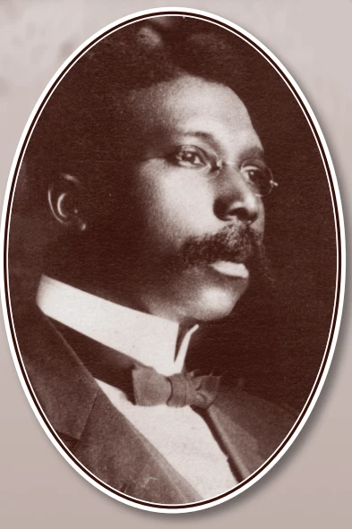 Black and white portrait of Eugene Covington, a Black man wearing small oval glasses, and a suit with a bow tie. He has a mustache and short hair.