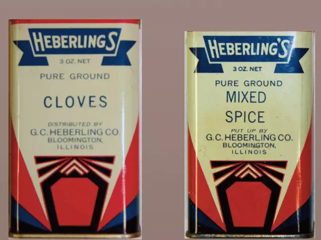 Photo of two spice tins: cloves and mixed spice. The tins are white with red and blue accents. Heberling's logo is at the top and looks like a blue ribbon.