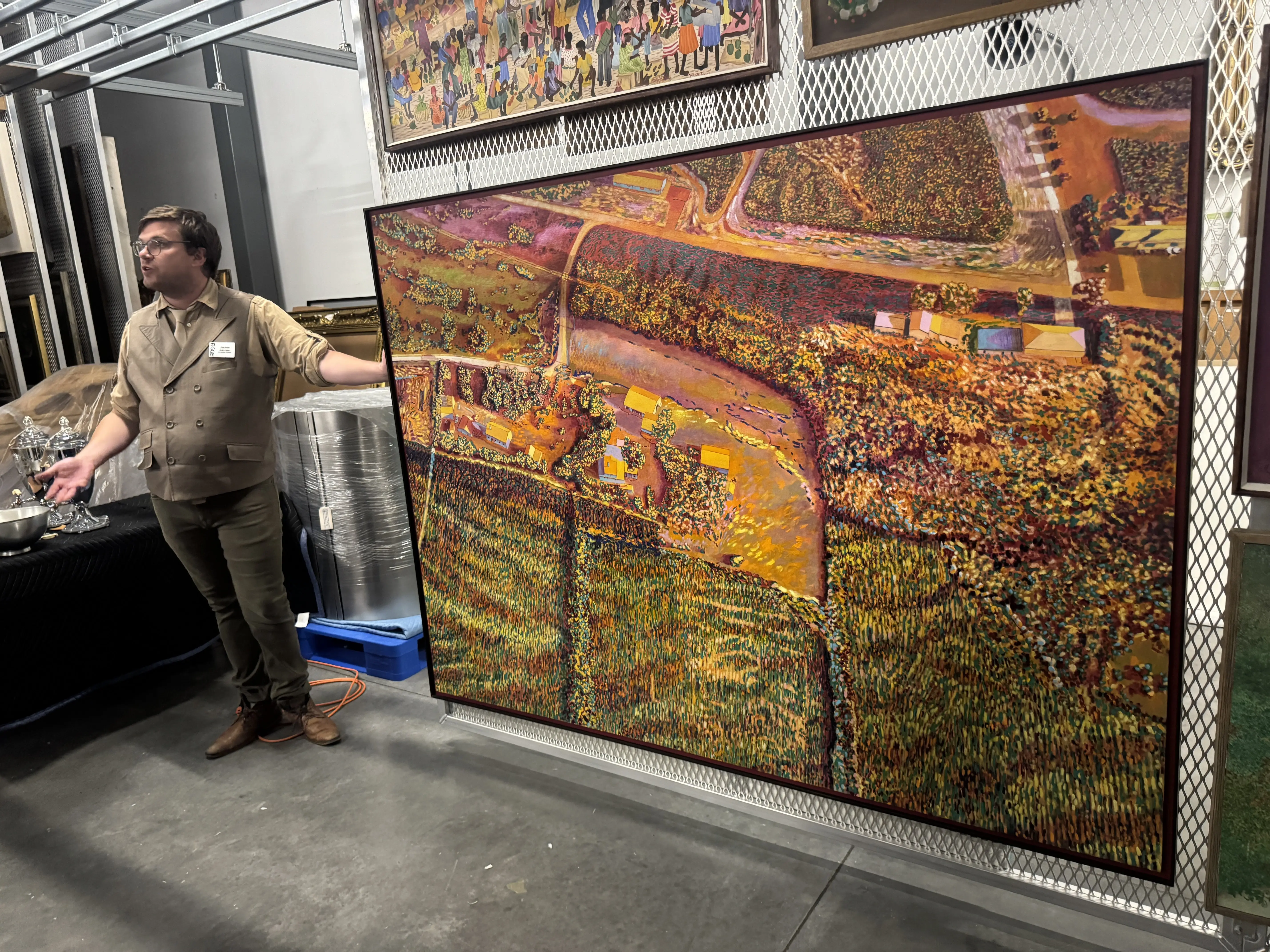 A man suit stands next to Harold Gregor's Illinois Flatscape #53