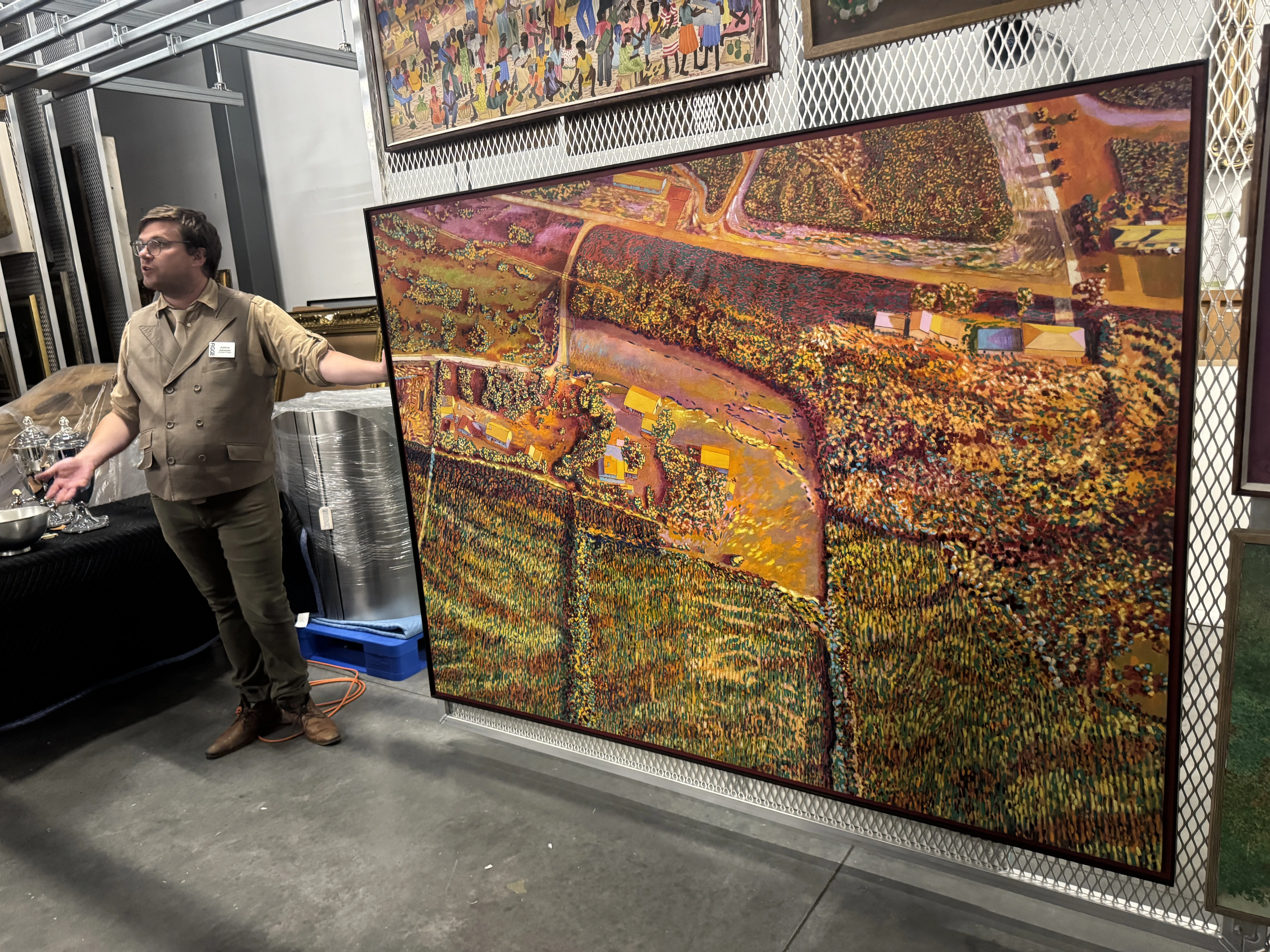 A man suit stands next to Harold Gregor's Illinois Flatscape #53