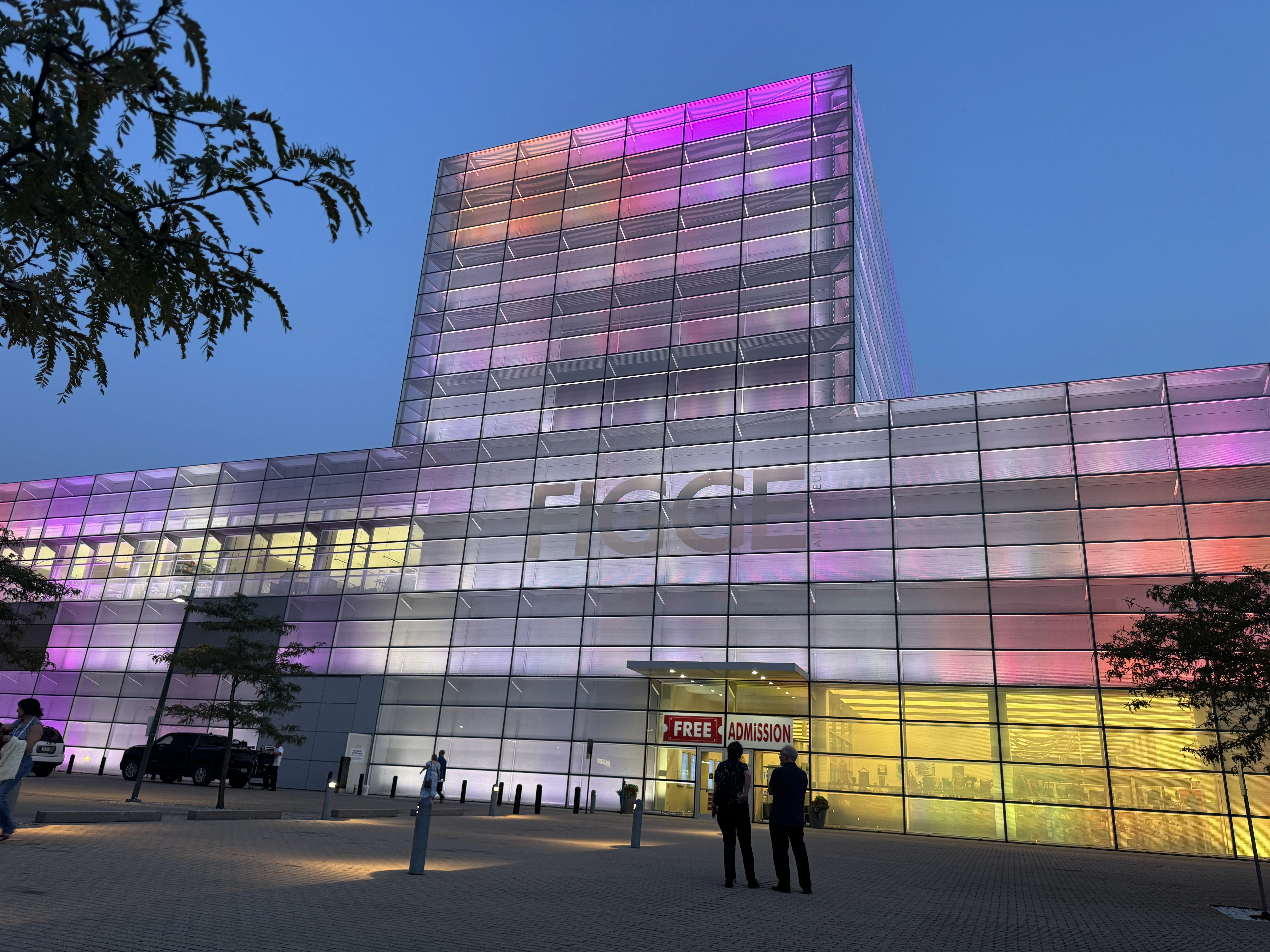 The Figge Art Musuem illuminated in tones of pink, orange, and yellow.