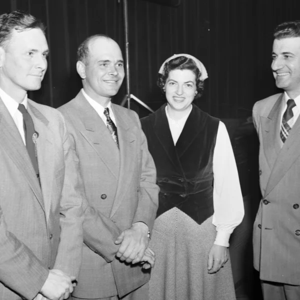 In 1953, two McLean County corn farmers broke the 100-bushels-per-acre barrier. Newell Henderson, left, of Stanford and Merle Kuehling of Arrowsmith, second from left, are seen here on March 9, 1954, at the McLean County 100 Bushel Corn Club’s annual banquet. Also shown are Phyllis Kuehling, Merle’s wife, and Farm Adviser Eugene Mosbacher, far right.
