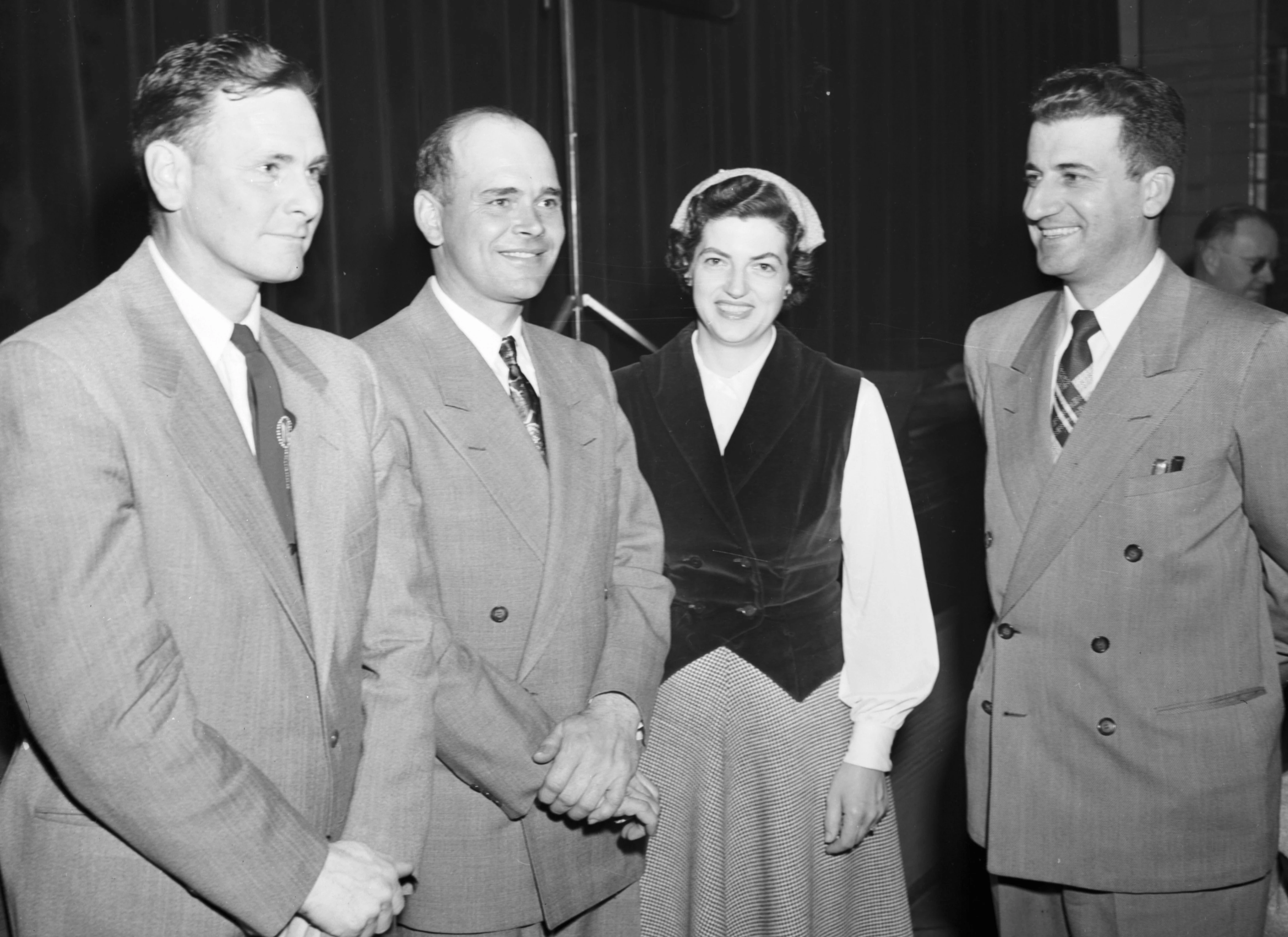 In 1953, two McLean County corn farmers broke the 100-bushels-per-acre barrier. Newell Henderson, left, of Stanford and Merle Kuehling of Arrowsmith, second from left, are seen here on March 9, 1954, at the McLean County 100 Bushel Corn Club’s annual banquet. Also shown are Phyllis Kuehling, Merle’s wife, and Farm Adviser Eugene Mosbacher, far right.