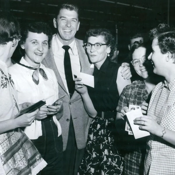 Regan stands in the middle of the photo surrounded by women
