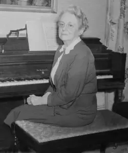 an older white woman seated at a piano.