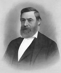 Portrait of Linus Graves, a middle-aged man wearing a white collared shirt, vest, and jacket, with full beard and large nose.