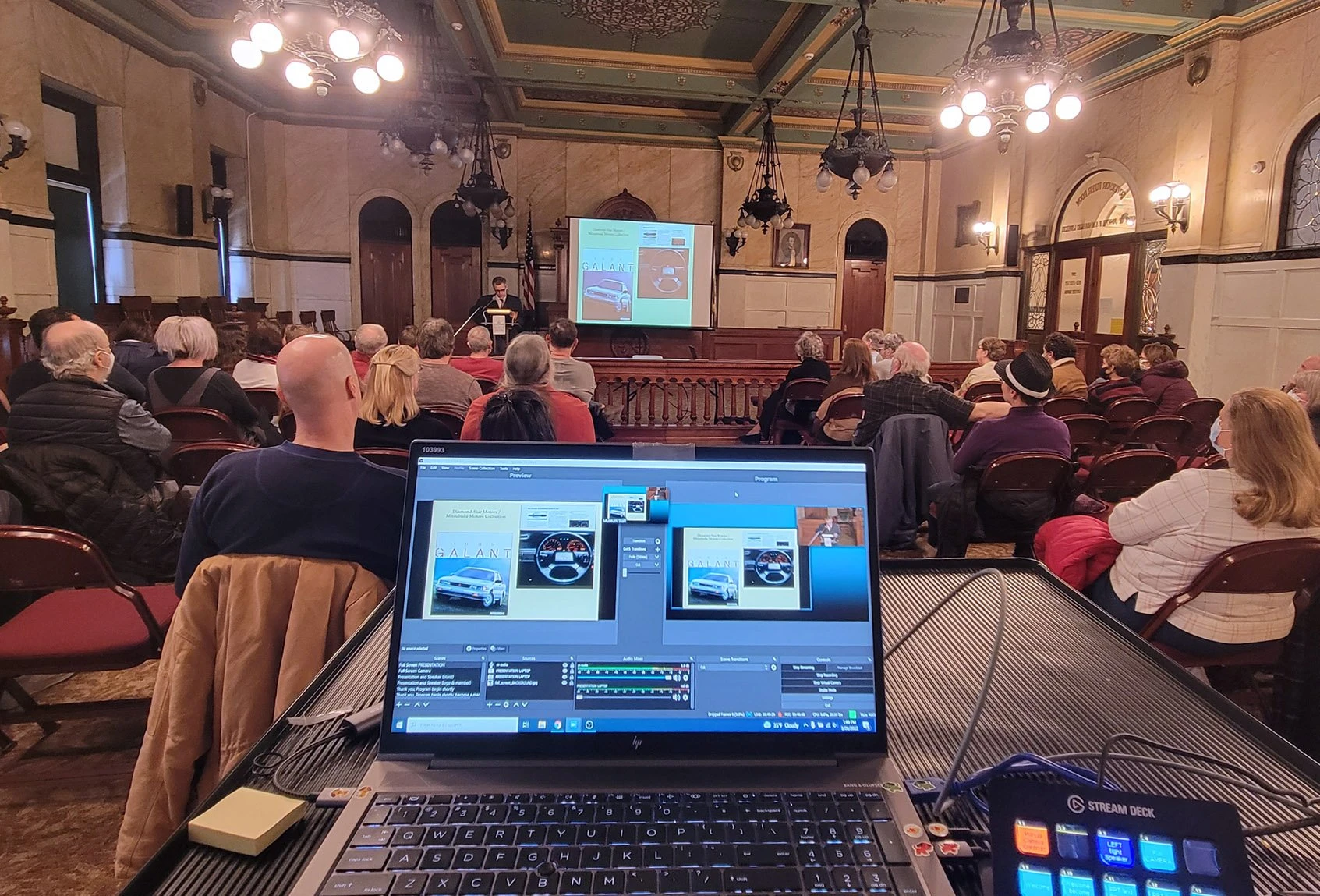courtoom full of people, with the livestream laptop in the foreground