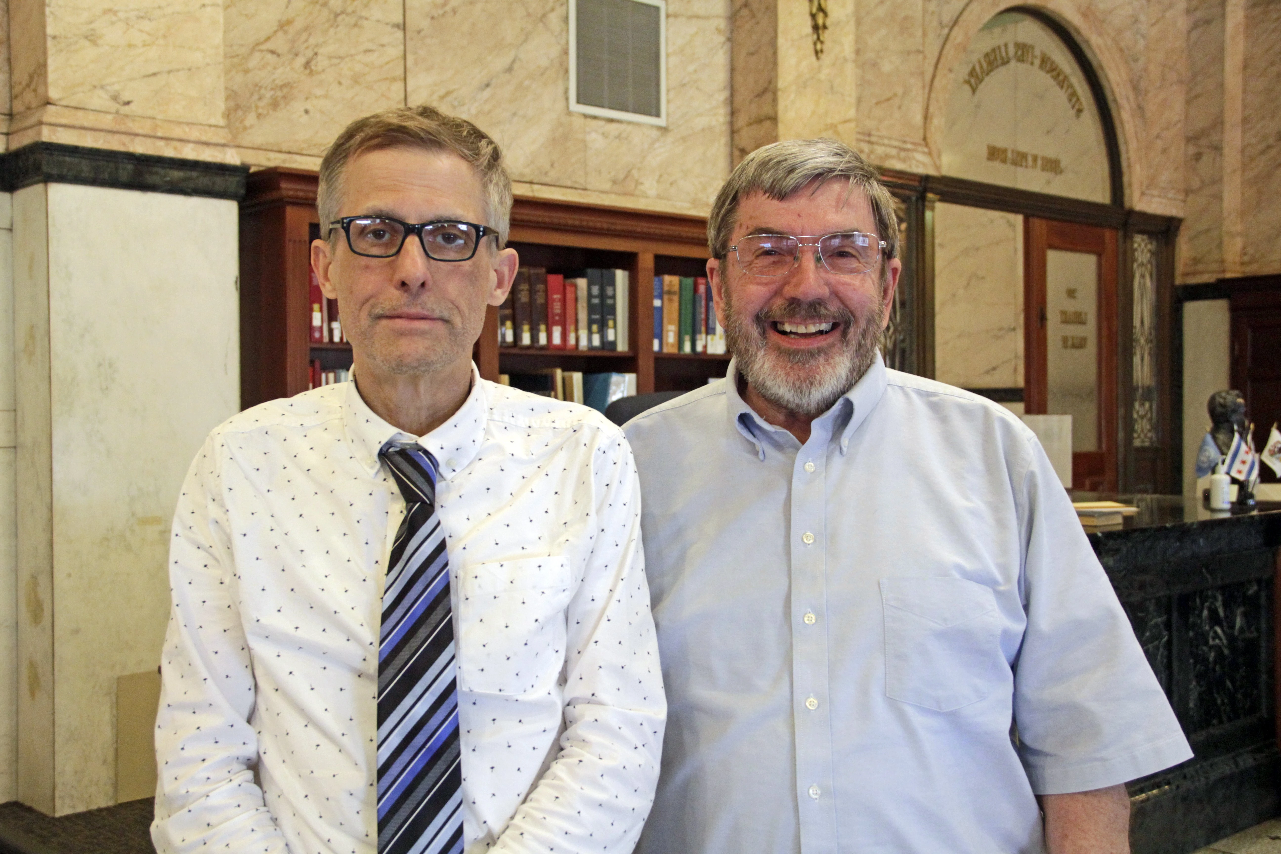 Bill Kemp and George Perkins pose in the library