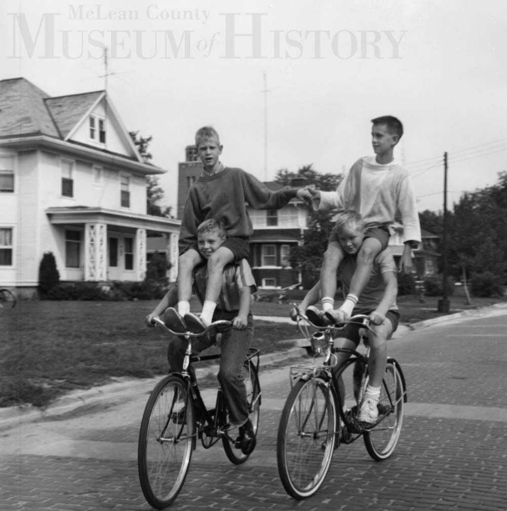 Four boys riding two bikes, 1963