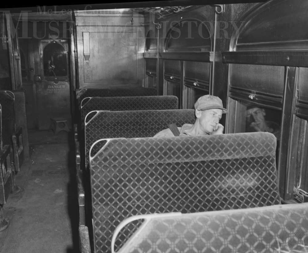 Man sitting in a train car, 1950.